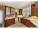 Modern kitchen featuring wood cabinetry, stainless steel appliances, and tile backsplash at 1108 64Th Street E Ct, Bradenton, FL 34208