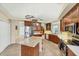 Gourmet kitchen with wood cabinets, granite counters, stainless steel appliances, and central island at 1108 64Th Street E Ct, Bradenton, FL 34208