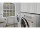 Laundry room with side-by-side washer and dryer, window and hanging rack at 1108 64Th Street E Ct, Bradenton, FL 34208