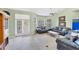 The living room is bright with tile flooring, and features neutral walls with large french doors at 1108 64Th Street E Ct, Bradenton, FL 34208