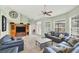 Open living room with tile flooring, neutral walls, and stylish furnishings including a ceiling fan at 1108 64Th Street E Ct, Bradenton, FL 34208