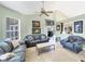 Spacious living area with neutral walls, tile flooring, stylish furnishings, and a ceiling fan at 1108 64Th Street E Ct, Bradenton, FL 34208