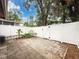 Fenced backyard featuring a tiled patio and well-maintained landscaping for relaxation and privacy at 11717 Wesson E Cir, Tampa, FL 33618