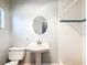 Bathroom featuring a pedestal sink, classic fixtures, and a tiled shower, offering a clean design at 11717 Wesson E Cir, Tampa, FL 33618