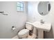 Cozy bathroom with a classic pedestal sink, neutral walls, and a tile floor, offering comfort at 11717 Wesson E Cir, Tampa, FL 33618