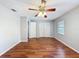 Bedroom with hardwood floors, a ceiling fan, a window, and a closet at 11717 Wesson E Cir, Tampa, FL 33618