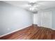 Bedroom featuring hardwood floors, a ceiling fan, and white closet doors at 11717 Wesson E Cir, Tampa, FL 33618