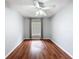 Bedroom featuring hardwood floors, a ceiling fan, and gray curtains framing the window at 11717 Wesson E Cir, Tampa, FL 33618