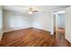 Cozy bedroom featuring hardwood floors, neutral walls, and natural light at 11717 Wesson E Cir, Tampa, FL 33618