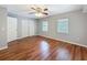 Bedroom with hardwood floors, a ceiling fan, two windows, and a closet at 11717 Wesson E Cir, Tampa, FL 33618