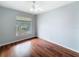 Bedroom featuring hardwood floors, a ceiling fan, and a view of the neighborhood from the window at 11717 Wesson E Cir, Tampa, FL 33618
