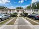 Exterior of townhomes with well-manicured front yards and private driveways at 11717 Wesson E Cir, Tampa, FL 33618