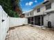 Back exterior view of home showcasing the screened patio and fenced backyard at 11717 Wesson E Cir, Tampa, FL 33618