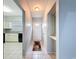 Inviting hallway with tile flooring leads to the kitchen with modern appliances and ample counter space at 11717 Wesson E Cir, Tampa, FL 33618