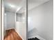 Well-lit hallway with hardwood floors and access to multiple rooms, freshly painted at 11717 Wesson E Cir, Tampa, FL 33618