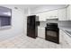 Bright kitchen with black appliances and white cabinets providing ample storage and cooking space at 11717 Wesson E Cir, Tampa, FL 33618