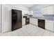 Well-lit kitchen featuring modern black appliances, ample counter space, and white cabinets at 11717 Wesson E Cir, Tampa, FL 33618