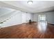 Expansive living room with rich wood floors, ample natural light, and staircase leading to a second level at 11717 Wesson E Cir, Tampa, FL 33618