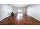Open living room area showcasing hardwood floors and sliding glass doors to the outside patio at 11717 Wesson E Cir, Tampa, FL 33618