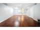 Bright living room featuring beautiful hardwood floors, a staircase, and an open layout at 11717 Wesson E Cir, Tampa, FL 33618