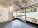 Enclosed patio area featuring a painted floor and a view of the fenced backyard at 11717 Wesson E Cir, Tampa, FL 33618