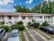 Charming townhome exterior with front yard landscaping, multiple parking spots, and neutral paint at 11717 Wesson E Cir, Tampa, FL 33618