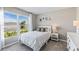 Bright bedroom features a large window with neighborhood views, neutral walls, and stylish decor at 12075 Mountain Island Trl, Parrish, FL 34219