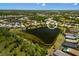 Aerial view of the community, showcasing the lake, surrounding homes, and lush landscape at 12116 Stuart Dr, Venice, FL 34293