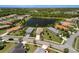 Picturesque aerial shot of residential homes surrounding a serene lake, showcasing neighborhood charm at 12116 Stuart Dr, Venice, FL 34293