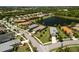 Overhead view of homes nestled near a scenic lake, with meticulously maintained landscapes at 12116 Stuart Dr, Venice, FL 34293