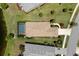 A bird's eye view of the house with a beautiful tile roof, screened-in pool, and meticulously maintained landscaping at 12116 Stuart Dr, Venice, FL 34293