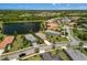 Beautiful aerial view of lakeside community homes featuring verdant lawns and tranquil water views at 12116 Stuart Dr, Venice, FL 34293