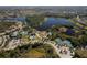 Scenic aerial view of a community with amenities like pools, tennis courts and playgrounds near a lake at 12116 Stuart Dr, Venice, FL 34293
