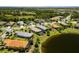 Aerial view of a beautiful neighborhood with a pond and mature trees at 12116 Stuart Dr, Venice, FL 34293