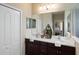 Double vanity bathroom featuring a large mirror and views into the bedroom at 12116 Stuart Dr, Venice, FL 34293