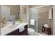 Well-lit bathroom with a glass shower, sink, toilet, and simple decorations at 12116 Stuart Dr, Venice, FL 34293