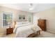 Comfortable bedroom with neutral tones, a ceiling fan, and view of the outdoors at 12116 Stuart Dr, Venice, FL 34293