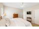 Bright bedroom featuring a ceiling fan, television, and a lovely wooden dresser at 12116 Stuart Dr, Venice, FL 34293