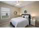 Stylish bedroom with a ceiling fan, mirror, and coordinated decor at 12116 Stuart Dr, Venice, FL 34293