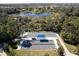 Aerial shot of bocce ball courts, including shelters, nestled in a community near a pond at 12116 Stuart Dr, Venice, FL 34293