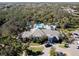Aerial view of community clubhouse and pool with parking and lush green landscape at 12116 Stuart Dr, Venice, FL 34293
