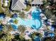 Overhead view of community pool featuring palm trees, lounge chairs, and geometric sundeck at 12116 Stuart Dr, Venice, FL 34293