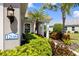Close-up showcasing the home's address and beautifully landscaped garden with mature plantings at 12116 Stuart Dr, Venice, FL 34293