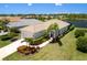 Beautiful single-story home with a tile roof, well manicured lawn and view of the lake at 12116 Stuart Dr, Venice, FL 34293