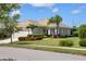 Well-manicured lawn and tropical landscaping frame this beautiful home with a tile roof and attached garage at 12116 Stuart Dr, Venice, FL 34293