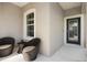 Covered front porch with seating and decorative door at 12116 Stuart Dr, Venice, FL 34293