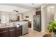 Open concept kitchen featuring stainless steel appliances and a view into the living room at 12116 Stuart Dr, Venice, FL 34293