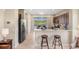 Open kitchen with stainless steel appliances, breakfast bar, and scenic views of the pool and lake at 12116 Stuart Dr, Venice, FL 34293