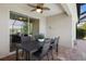 Outdoor patio with brick floors, table, chairs, and view of the backyard at 12116 Stuart Dr, Venice, FL 34293