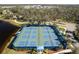 Aerial view of active pickleball courts in a community setting near lake and sidewalks at 12116 Stuart Dr, Venice, FL 34293